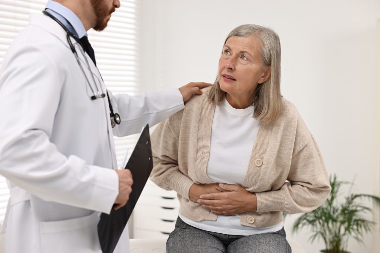 woman speaking to doctor about stomach GI-issues